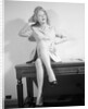 Woman Seated on Desk with Legs Crossed by Anonymous
