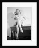 Woman Seated on Desk with Legs Crossed by Anonymous