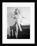 Woman Seated on Desk with Legs Crossed by Anonymous