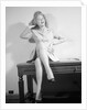 Woman Seated on Desk with Legs Crossed by Anonymous