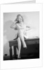 Woman Seated on Desk with Legs Crossed by Anonymous