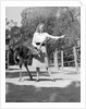 Woman Feeds Ostrich Orange on Farm by Anonymous