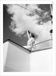 Woman Sitting on Ship Railing by Anonymous
