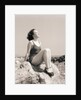 Young Woman Sitting on Beach Rocks by Anonymous