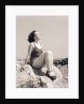 Young Woman Sitting on Beach Rocks by Anonymous