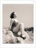 Young Woman Sitting on Beach Rocks by Anonymous