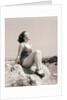 Young Woman Sitting on Beach Rocks by Anonymous
