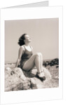 Young Woman Sitting on Beach Rocks by Anonymous