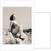 Young Woman Sitting on Beach Rocks by Anonymous