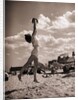 Young Woman Playing Ball On Beach by Anonymous