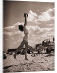 Young Woman Playing Ball On Beach by Anonymous