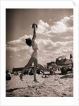 Young Woman Playing Ball On Beach by Anonymous
