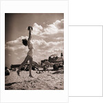 Young Woman Playing Ball On Beach by Anonymous
