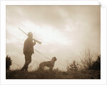 Silhouette of Hunter with Bird Dog Under Clouds by Anonymous