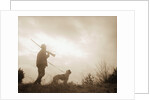 Silhouette of Hunter with Bird Dog Under Clouds by Anonymous