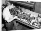 Man Working with Lathe in Basement Workshop by Anonymous