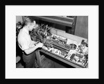 Man Working with Lathe in Basement Workshop by Anonymous