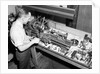 Man Working with Lathe in Basement Workshop by Anonymous