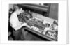 Man Working with Lathe in Basement Workshop by Anonymous