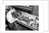 Man Working with Lathe in Basement Workshop by Anonymous