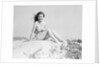 Young Woman Seated on Sand Dune by Anonymous