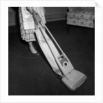 Woman Vacuuming by Anonymous