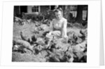 Woman Sits And Hand Feeds Chickens by Anonymous