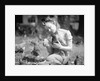 Woman Holds Chicken For Feeding by Anonymous