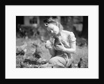Woman Holds Chicken For Feeding by Anonymous