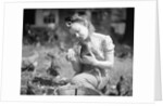 Woman Holds Chicken For Feeding by Anonymous