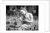 Woman Holds Chicken For Feeding by Anonymous