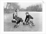 Man Lacing a Woman's Ice Skate by Anonymous