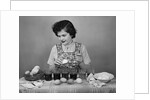 Girl Coloring Easter Eggs by Anonymous
