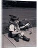 Boy Fallen Off Tricycle and Holding Knee by Anonymous