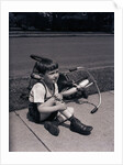 Boy Fallen Off Tricycle and Holding Knee by Anonymous