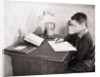 Boy Writing at Desk by Anonymous