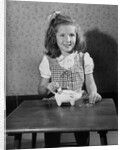 Girl Putting Money In Piggy Bank by Anonymous