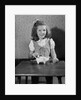 Girl Putting Money In Piggy Bank by Anonymous
