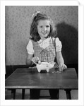 Girl Putting Money In Piggy Bank by Anonymous