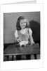 Girl Putting Money In Piggy Bank by Anonymous