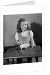 Girl Putting Money In Piggy Bank by Anonymous