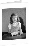 Girl Putting Money In Piggy Bank by Anonymous