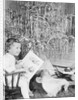 Girl Sitting Beside Christmas Tree by Anonymous