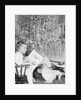 Girl Sitting Beside Christmas Tree by Anonymous