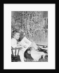 Girl Sitting Beside Christmas Tree by Anonymous