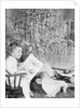 Girl Sitting Beside Christmas Tree by Anonymous