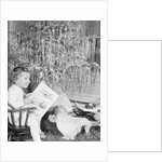 Girl Sitting Beside Christmas Tree by Anonymous