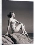 Young Woman in Swimsuit Seated on Rock by Anonymous