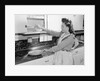 Woman Putting Dishes In Cabinet by Anonymous