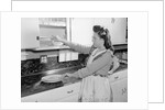 Woman Putting Dishes In Cabinet by Anonymous